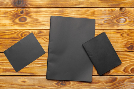 Mockup of black paper on wooden table