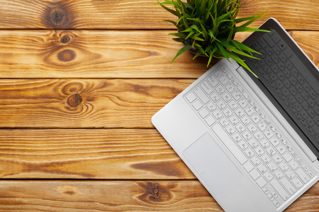 Laptop, notebook on work wooden deskの写真素材