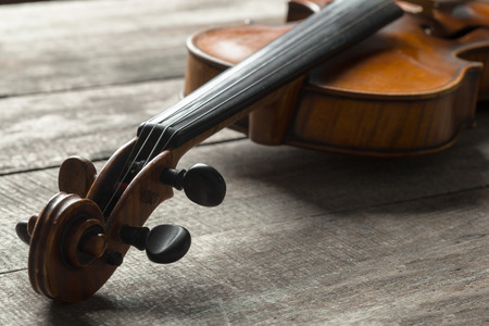 Violin on a wooden textured tableの写真素材