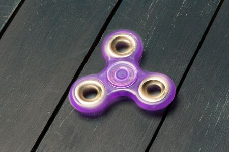 spinner on a wooden table. close upの写真素材