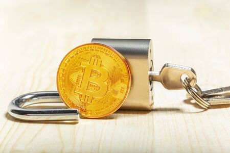 Gold bitcoin and padlock