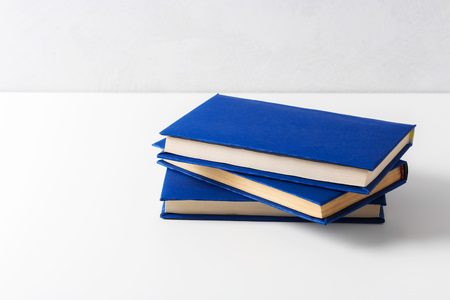 pile of paperback books on a tableの写真素材