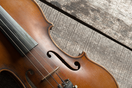 Violin on a wooden textured tableの写真素材