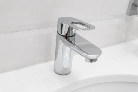 chrome faucet in modern bathroomの写真素材