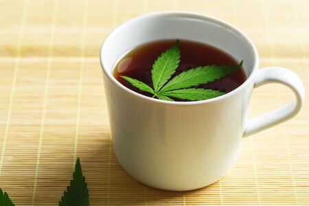 Cannabis herbal tea and marijuana leavesの写真素材