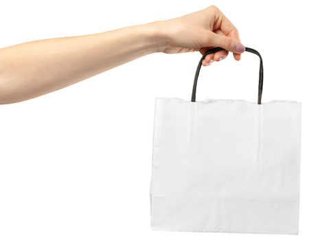 Shopping Bag. Female hand holding shopping bag on whiteの写真素材