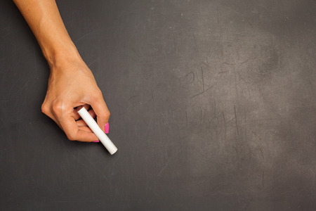 Hand holding chalk pieceの写真素材