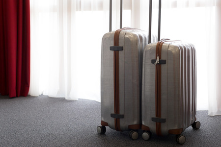 Suitcase or luggage bag in a modern hotel roomの写真素材