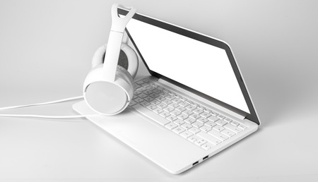 laptop and headphone isolated on whiteの写真素材