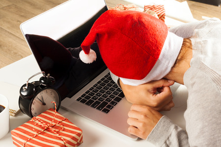 Businessman celebrating christmas holiday in the officeの写真素材