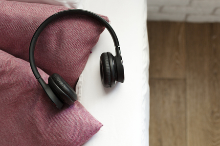 headphone lying on pillow for listening relax musicの写真素材