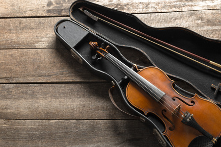 Violin on a wooden textured tableの写真素材