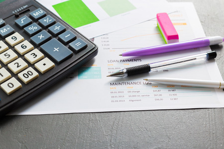 Checking accounting report on business table. Calculator