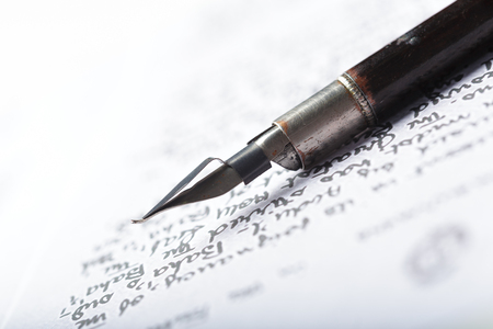 Fountain pen on an antique handwritten letterの写真素材