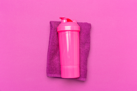 Pink plastic protein shaker cup on pink backgroundの写真素材