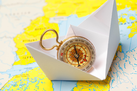 Origami paper ship on a map. Leadership and travelling conceptの写真素材