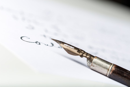 Fountain pen on an antique handwritten letterの写真素材