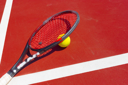 Tennis balls and racket on the grass court