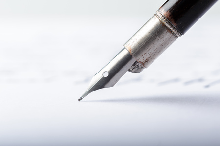 Fountain pen on an antique handwritten letter