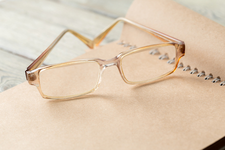 notepad and eyeglasses on the tableの写真素材
