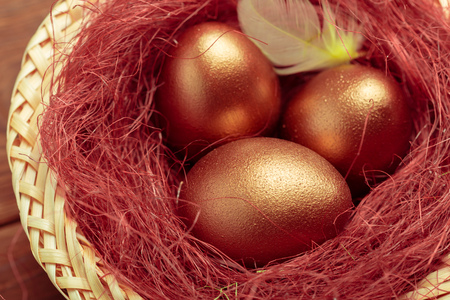 Gold eggs on wooden tableの写真素材