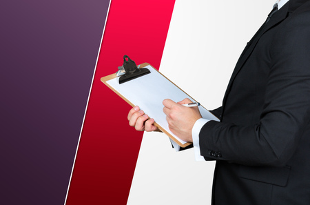 Unrecognizable businessman holding blank piece of paper with copy space