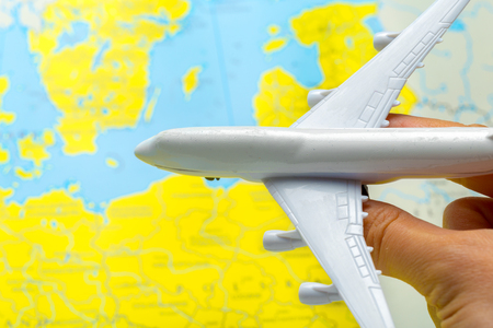 miniature of a passenger aircraft flying on a mapの写真素材
