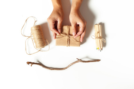Woman's hands wrapping a giftの写真素材