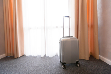 Suitcase or luggage bag in a modern hotel roomの写真素材