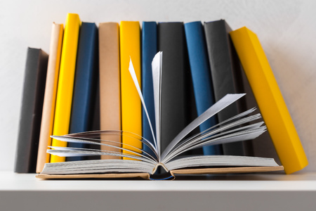 pile of paperback books on a table