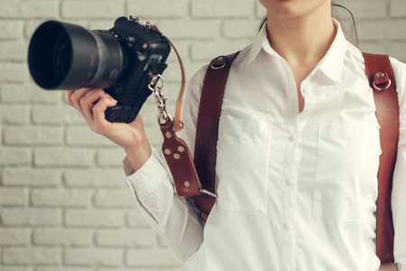 Pretty woman is a professional photographer with dslr cameraの写真素材