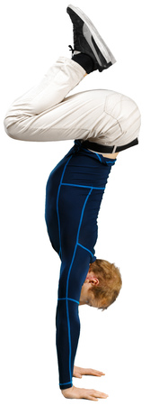 Flexible sporty young man doing stretching exercises isolated on white background