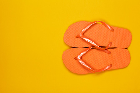 Beach flip flop on color backgroundの写真素材