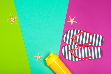 Beach flip flop on color background