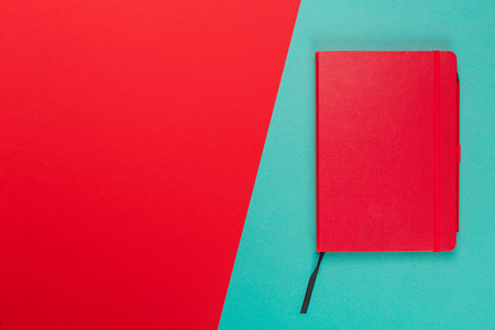 Notepad on a bright colored background, top viewの写真素材