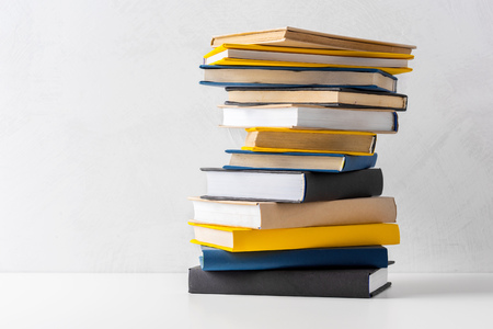 pile of paperback books on a tableの写真素材
