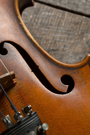 Violin on a wooden textured tableの写真素材