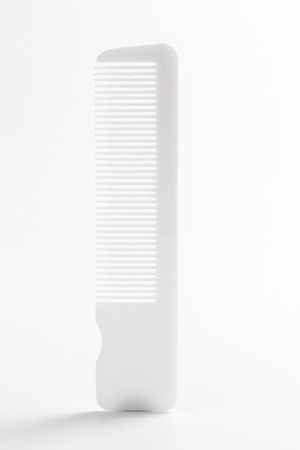 White plastic hair comb isolated on white backgroundの写真素材