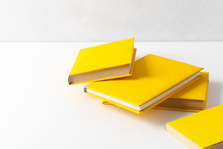 pile of paperback books on a tableの写真素材