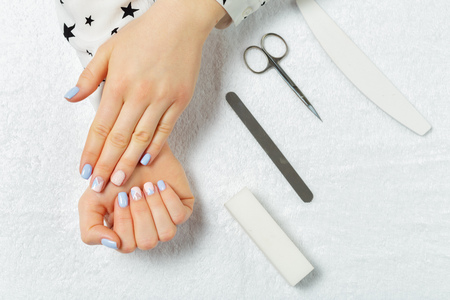 Woman hands receiving a manicure in beauty salonの写真素材