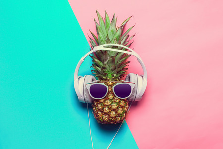 pineapple on colored paper with glassesの写真素材
