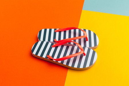 Female flip flops on a colorful vibrant background
