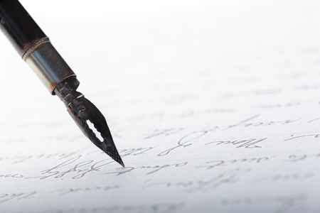 Fountain pen on an antique handwritten letterの写真素材