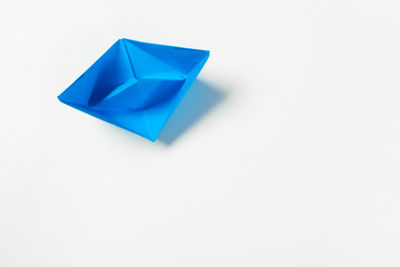 origami paper boat isolated on white backgroundの写真素材