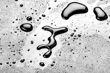 water drops splash on the black floorの写真素材