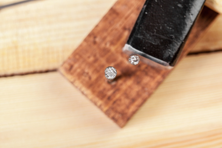 Hammer and nails on wood background