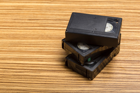 video tape cassette over wooden background