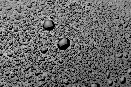water drops splash on the black floorの写真素材