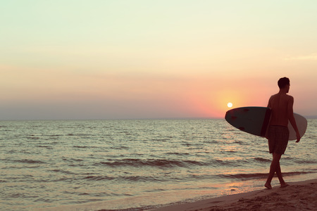 A surfer at sunset.