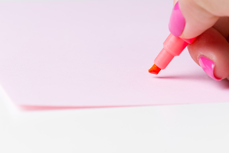 Female hand holding a pen close upの写真素材